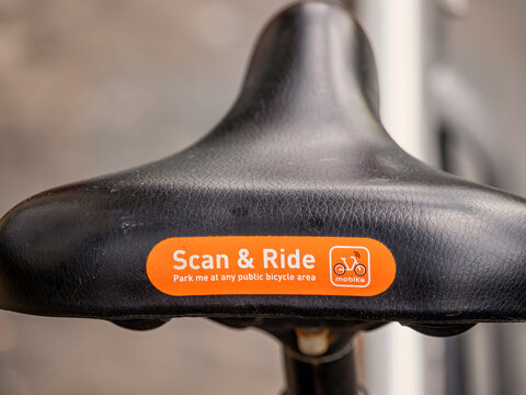 LONDON, UK - APRIL 27, 2019:  Saddle of Mobike bike sharing cycle showing Scan and Ride label