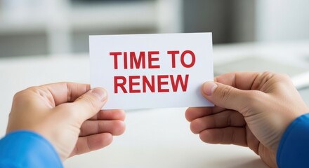 Hands holding a white card with bold red text saying TIME TO RENEW, an important reminder for action