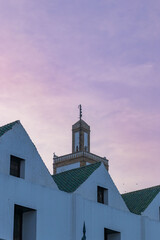 Fototapeta premium Traditional Moroccan architecture in Casablanca at sunset with pastel sky. Urban cityscape with cultural details.