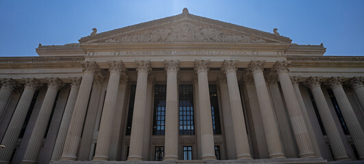 Naklejka premium Archives of the United States of America. Archives of the USA building with monumental neoclassical columns. Archives historic building in America. Classical columned facade of the Archives of the