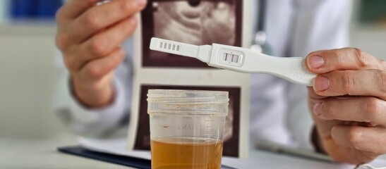 Evaluation of urine test results positive pregnancy test and ultrasound concept