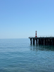 Fototapeta premium Old pier with lighthouse, Alushta, Crimea.