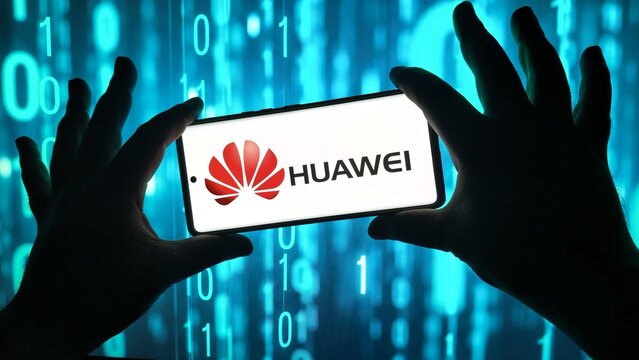 Person holding smartphone with huawei logo against binary code