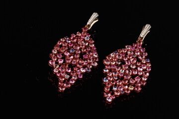 Elegant leaf-shaped dangle earrings featuring soft pink gemstones in a graceful, nature-inspired design. This refined jewelry piece combines organic form with modern elegance, making it ideal for fash