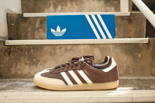 Bangkok,Thailand - January 1,2026 : Adidas Originals Samba brown color unboxing, Unboxing new adidas samba classic og shoes on blue box in Bangkok, Thailand.