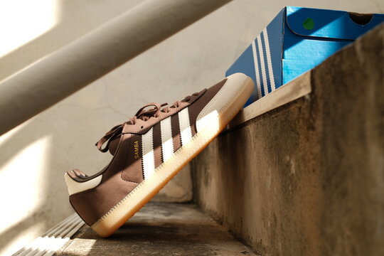 Bangkok,Thailand - January 1,2026 : Adidas Originals Samba brown color unboxing, Unboxing new adidas samba classic og shoes on blue box in Bangkok, Thailand.