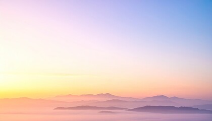 Obraz premium Mountains silhouetted at dawn beneath a pastel-colored sky