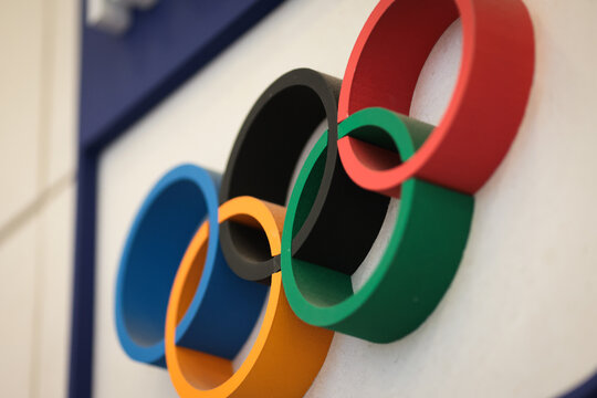 Bucharest, Romania - January 16, 2026: Shallow depth of field details with dusty Olympic Games rings made from wood on a wall