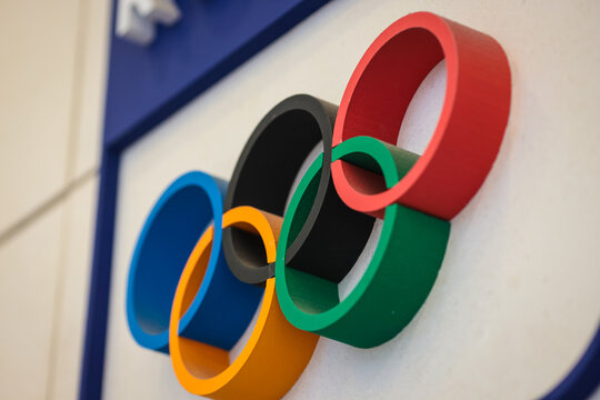 Bucharest, Romania - January 16, 2026: Shallow depth of field details with dusty Olympic Games rings made from wood on a wall