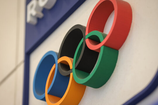 Bucharest, Romania - January 16, 2026: Shallow depth of field details with dusty Olympic Games rings made from wood on a wall