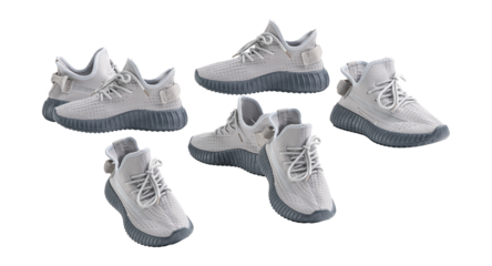 a dynamic grouping of five modern grey knit sneakers, artfully arranged against a transparent background, showcasing their athletic design and casual style.