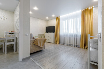 Contemporary studio apartment interior with living and dining zones