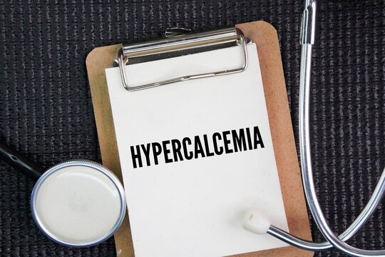 Stethoscope and whiteboard with the word hypercalcemia. condition in which the calcium level in the blood becomes too high