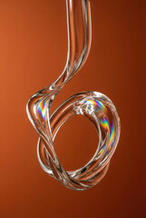 Abstract glass twist orange, Transparent liquid loop shape, Twisted crystal light refraction, Glossy 3d swirl spectrum color