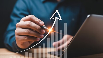 Financial analyst drawing a rising growth arrow on a bar graph chart for business success forecasting.