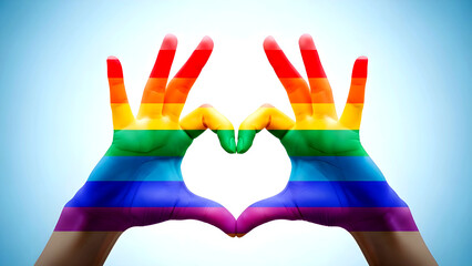 Two hands creating a heart shape, overlaid with vibrant rainbow colors, symbolizing love and pride