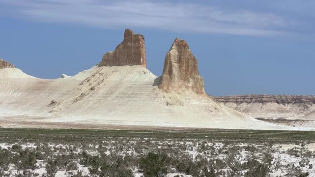 Mount Bozzhira. View of two cliffs called "Fangs" on the Ustyurt Plateau in Kazakhstan. White cliffs in the vast valley of the Mangystau Region. Bozzhira tract. The bottom of the former Tethys Ocean. 