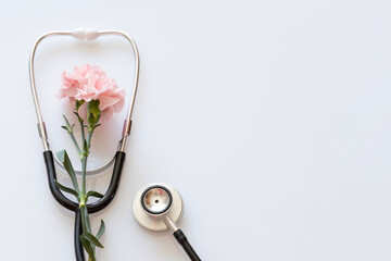 Stethoscope With Pink Flower On Blue Background Celebrating Healthcare Appreciation. Concept Of Medical Worker Gratitude, International Nurses Day, Doctor&rsquo;s Day And Wellness-Driven Seasonal Campaigns