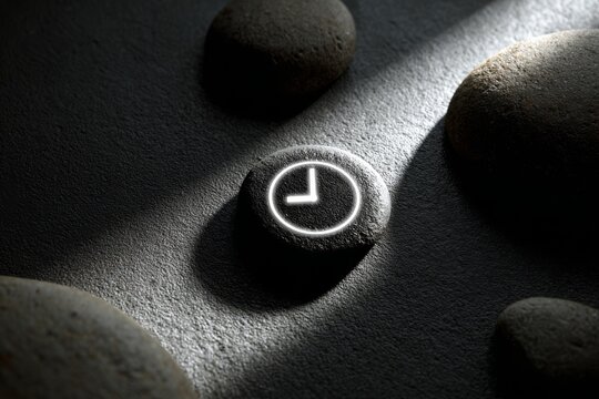 Minimal time symbol embedded in stone, representing productivity, efficiency, and the value of time.