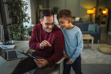 Father and son bonding during remote work at home