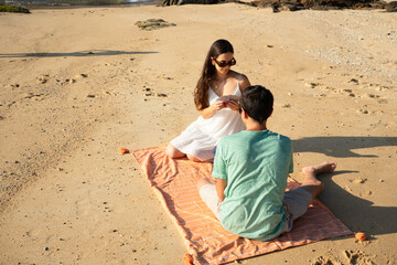 Couple playing cards relaxing on beach vacation
