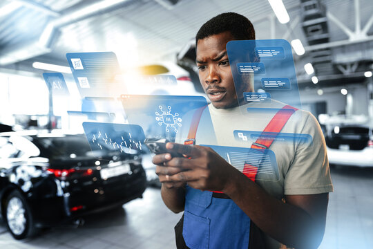 Young man checks data on phone in car service shop with digital display