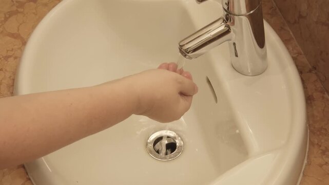 Woman brushing her teeth in front sink, practicing daily oral hygiene, preventing gum inflammation and periodontitis, healthy teeth, gums and dental care routine, Morning ritual for strong teeth