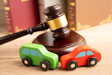 Car accident lawsuit and insurance, Judge hammer with car model.