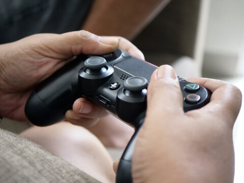 Hands Holding a Video Game Controller on January 04, 2026 in Jakarta, Indonesia