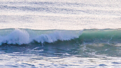 Fototapeta premium Translucent Green Breaking Wave at Sunrise