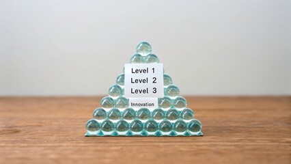 A Glass Bead Pyramid with Level Labels Showcasing Business Innovation and Progress