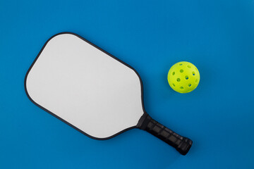 Pickleball Paddle and Ball on a blue background