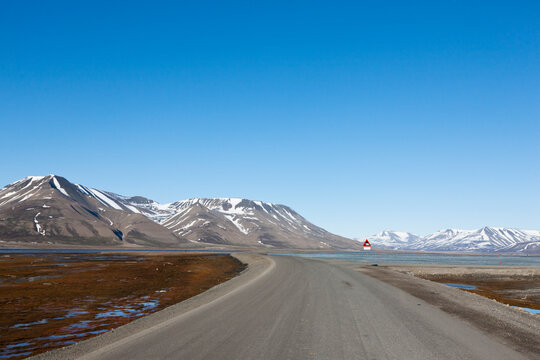 Polar bear warning road sign in arctic landscape near Longyearbyen Svalbard