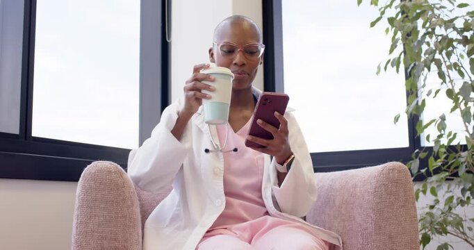 Smartphone alert appearing, clinician reading message and sipping cup during clinic break