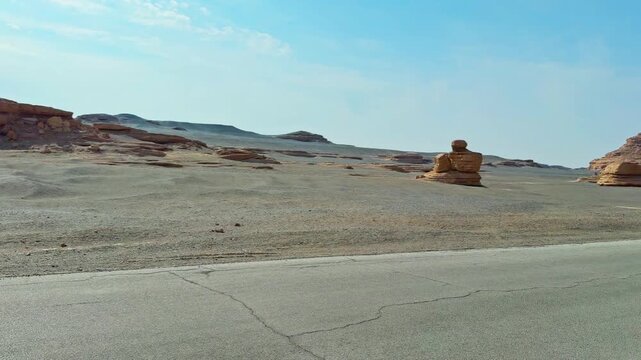 Asphalt Road Through The Deserts Of Dunhuang Yardang National Geopark In China. Panning Shot