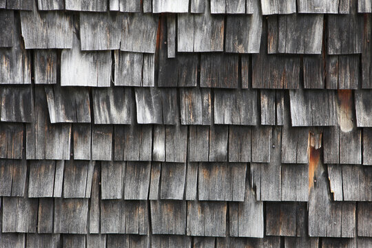 Withered wooden shingle wall detail of old house in Austria