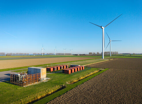 Battery storage and wind turbines on Dutch windfarm landscape