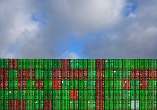Shipping containers stacked in Rotterdam harbour under cloudy sky