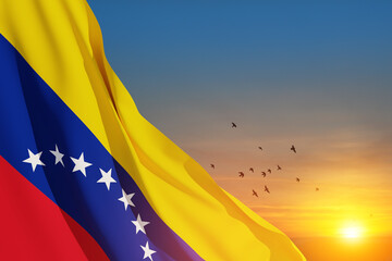 Fototapeta premium Venezuela flag on background of sunset sky with flying birds. Patriotic concept. Banner with place for text.