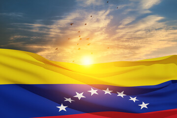 Fototapeta premium Venezuela flag on background of sunset sky with flying birds. Patriotic concept. Banner with place for text.