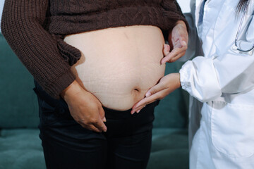 cropped shot of doctor examining pregnant woman during medical consultation