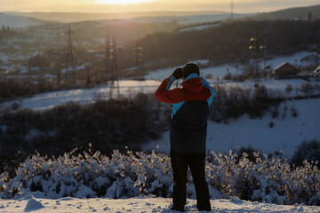 Man traveling, exploring, enjoying the view of the mountains, landscape, lifestyle concept winter vacation outdoors.