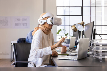 Virtual reality headset sitting on desk, with laptop, coffee, plant and sketches