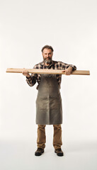 A carpenter inspecting a plank of wood for straightness one eye closed