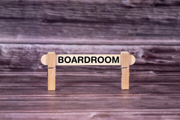 Fototapeta premium Boardroom symbol. Wooden stick held by Clothespins, beautiful Realistic Grunge Wooden Background. Business and Boardroom concept with copy space