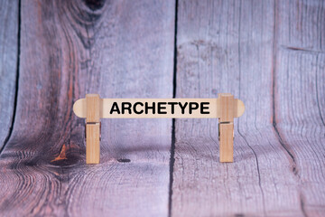 Fototapeta premium Archetype symbol. Single Wooden stick supported by Clothespins, beautiful Light Orange tone highlight Wooden Texture Background. Business and Archetype concept with copy space