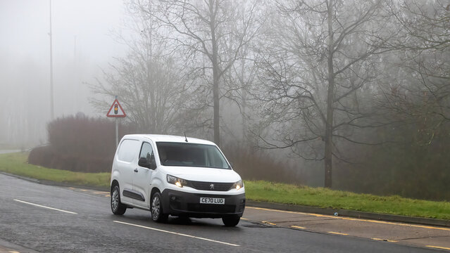 Milton Keynes,Bucks,UK - Jan 18th 2026:  2021 white Peugeot Partner diesel engine van  driving on a British road on a damp,foggy morning.