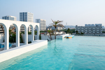 Infinity pool overlooks sunny urban skyline © zhu difeng