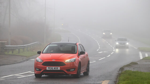 Milton Keynes,Bucks,UK - Jan 18th 2026: 2016 red Ford Focus  car driving on a British road on a damp,foggy morning.