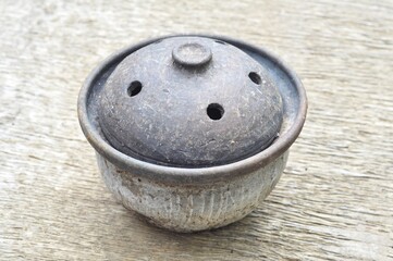Rustic Clay Pot with Lid on Wooden Background